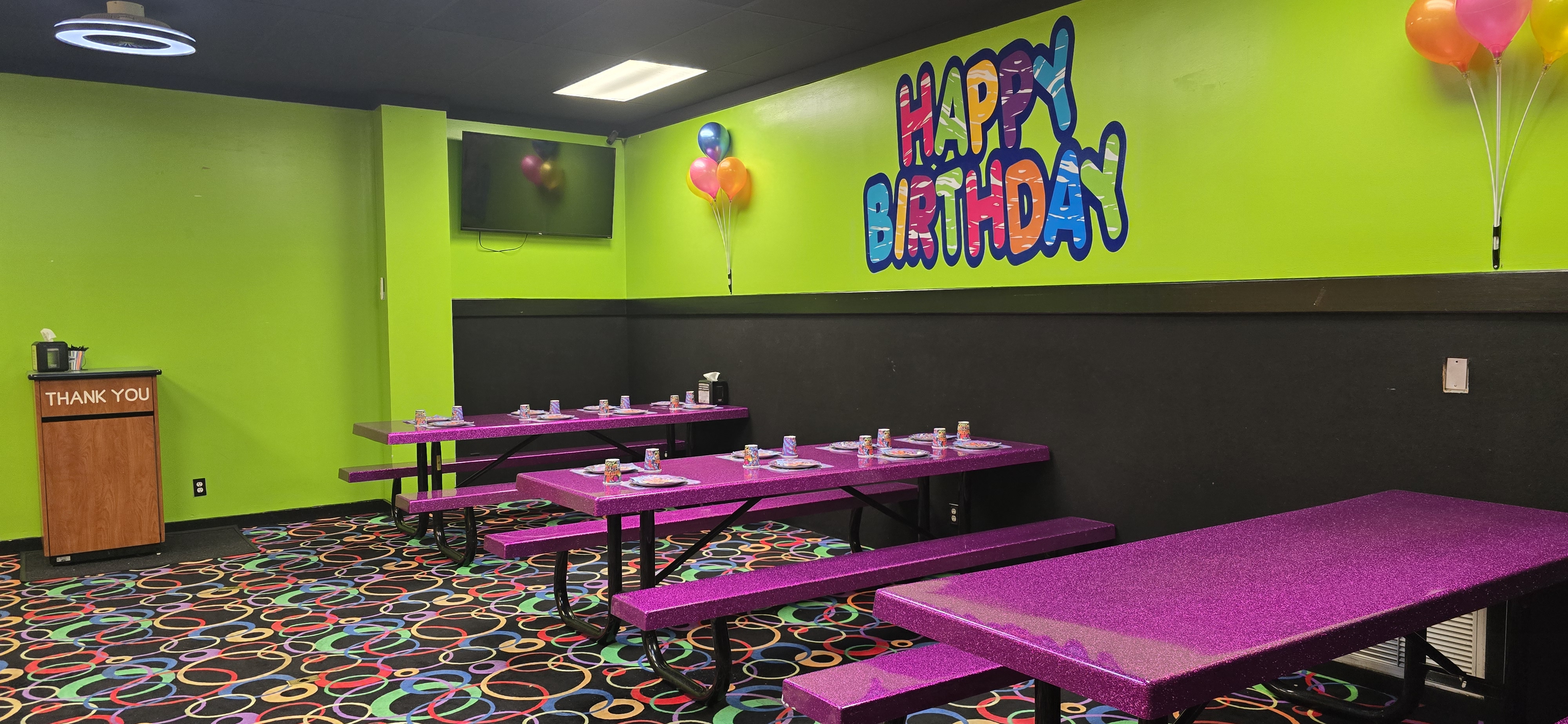 Roller City party room with balloons and picnic tables